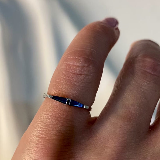 14k white gold ring with two blue tapered baguette sapphires modeled on womens hand