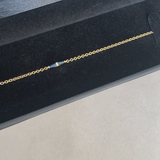 14K gold bracelet with a geometric blue sapphire detail presented inside a jewelry box
