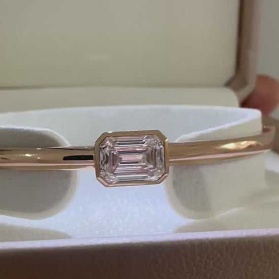 14K gold emerald cut diamond bangle presented in jewelry box packaging