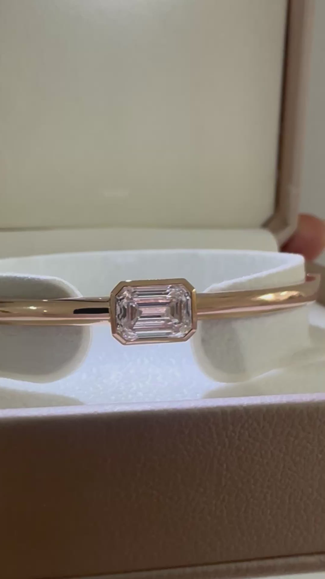 14K gold emerald cut diamond bangle presented in jewelry box packaging