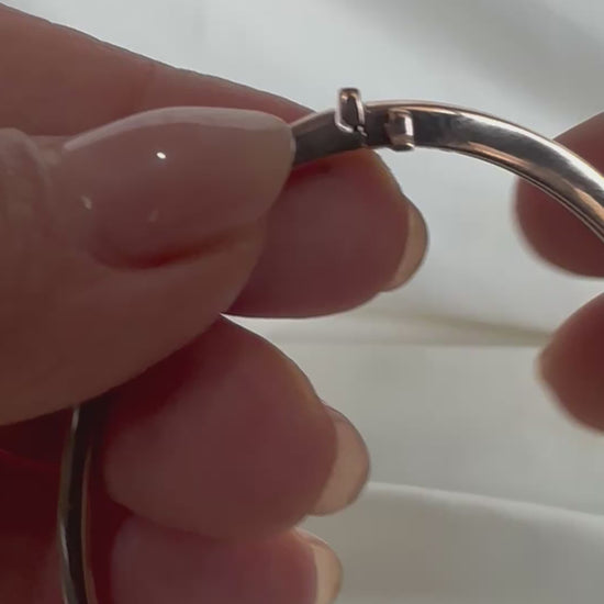 14K gold flush-set diamond bangle — clasp mechanism in motion