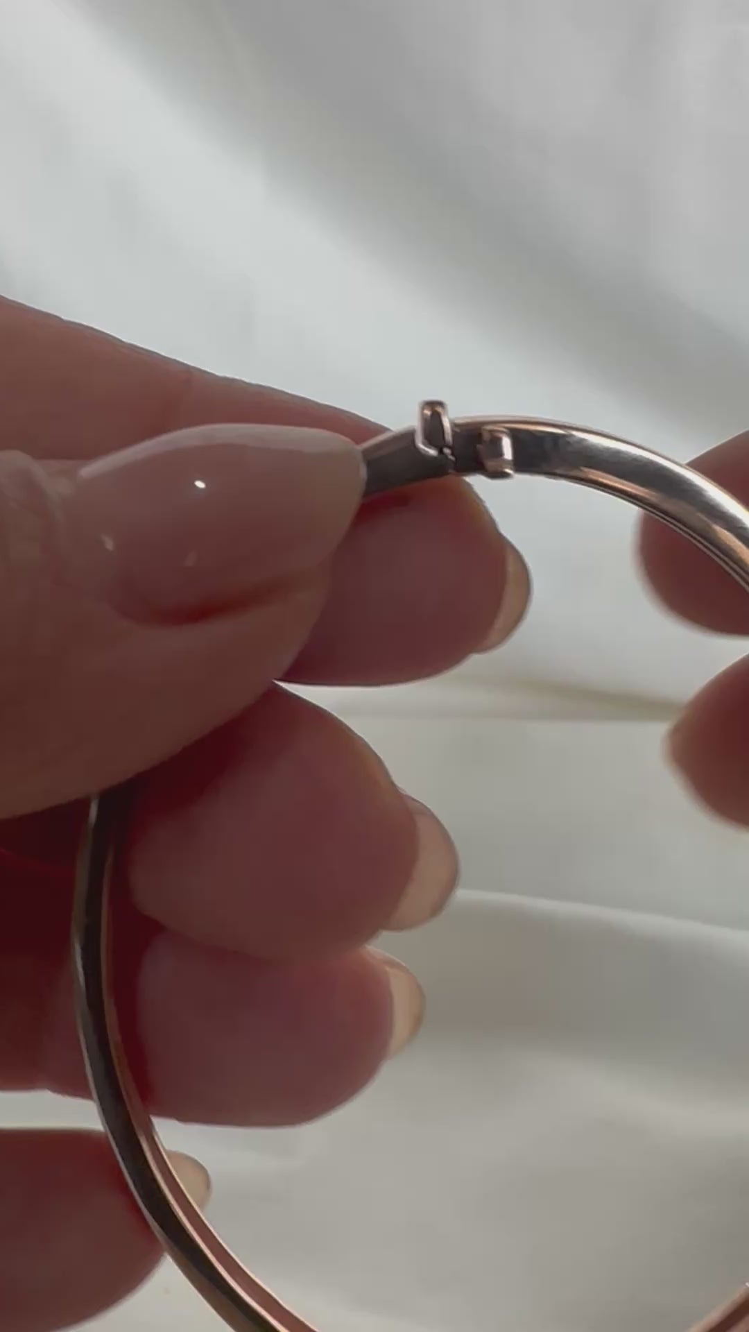 14K gold flush-set diamond bangle — clasp mechanism in motion