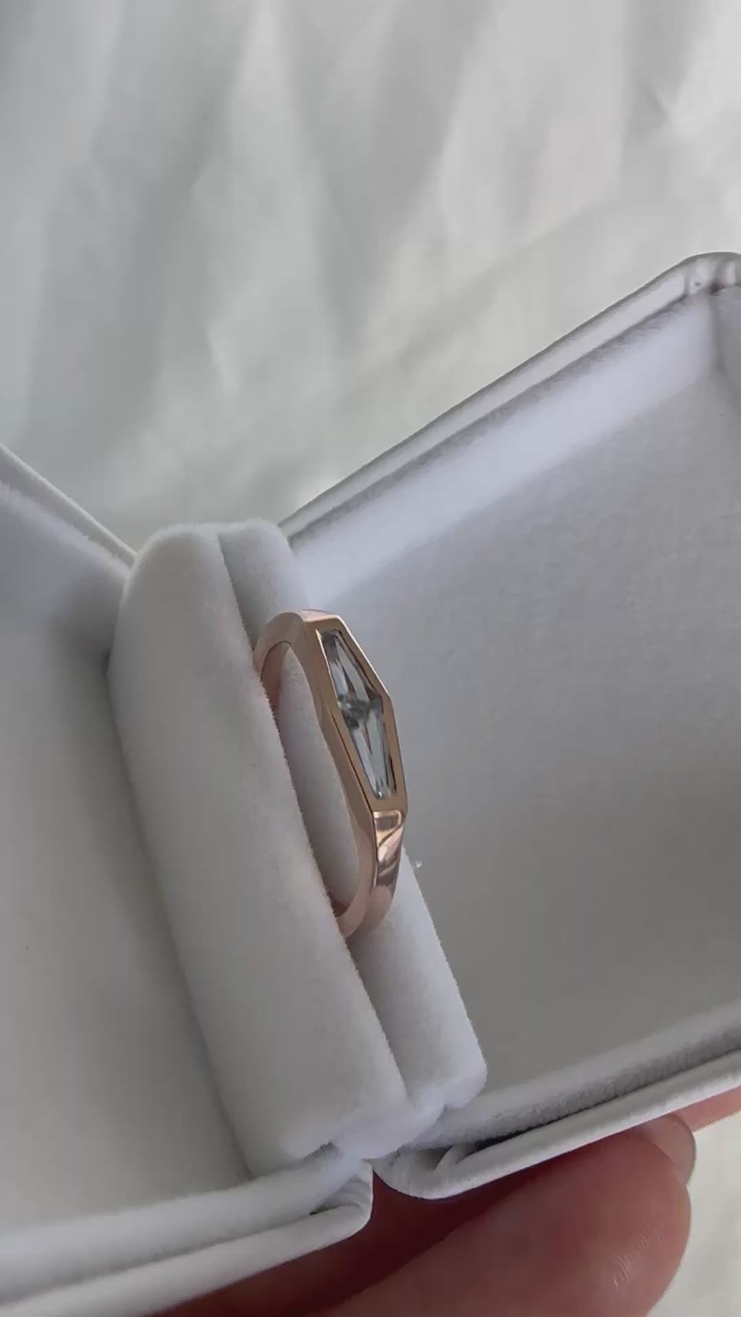 Video of a tapered baguette natural aquamarine two-stone ring in 14K rose gold, rotating to show the stones