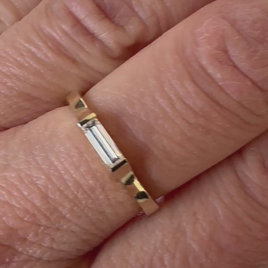 East-west baguette diamond ring shown on the hand