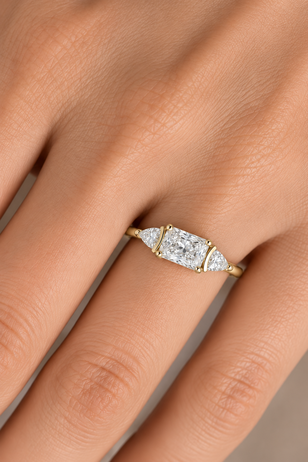Radiant-cut diamond engagement ring worn on a hand, showing scale and fit