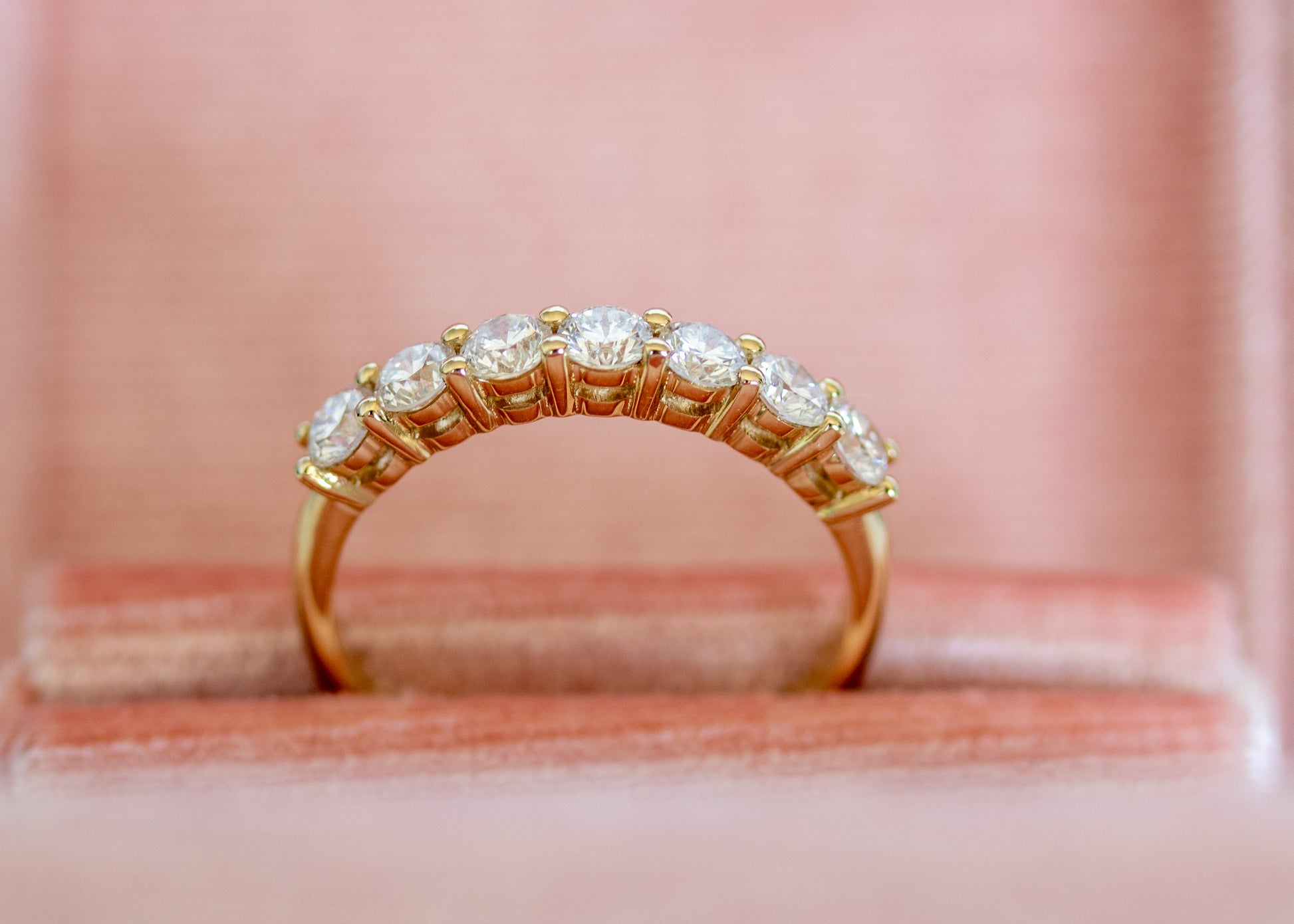 Close-up of round diamonds in a blush jewelry box