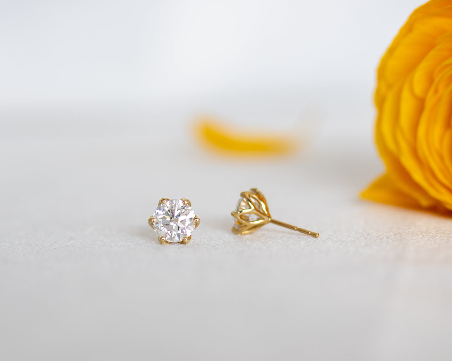 Round diamond solitaire stud earring in 14K gold, front view