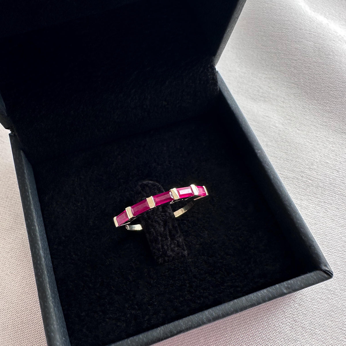 Ruby baguette band in 14K yellow gold in a black velvet box