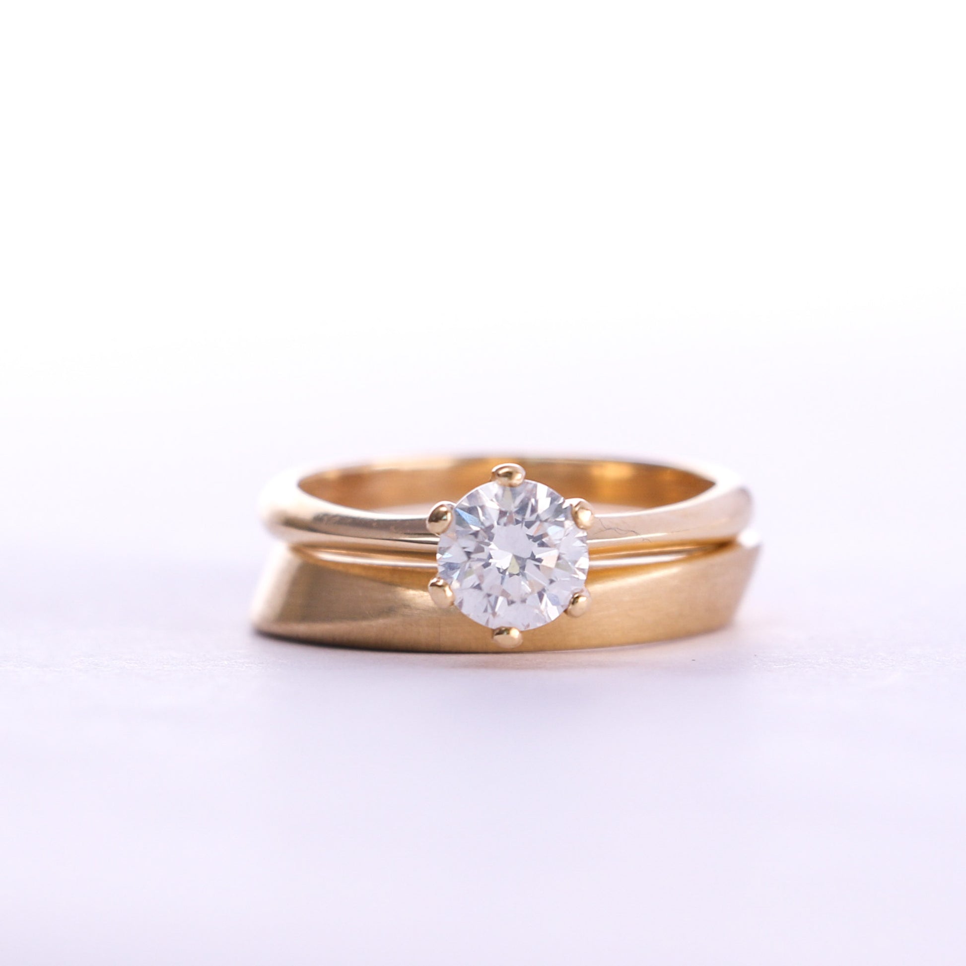 classic yellow gold engagement ring stacked with modern wedding band