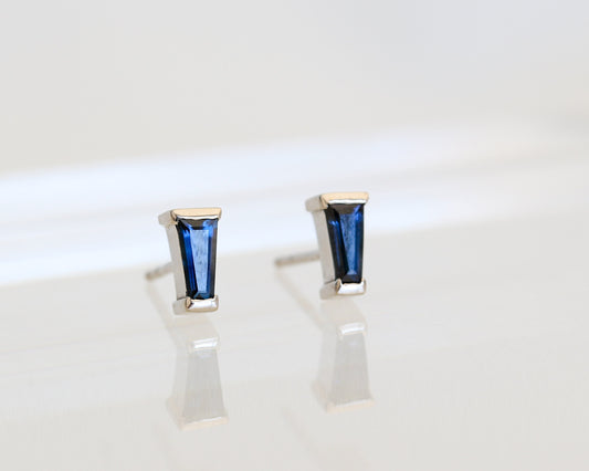 Blue tapered baguette sapphire stud earrings bar-set in white gold, standing upright
