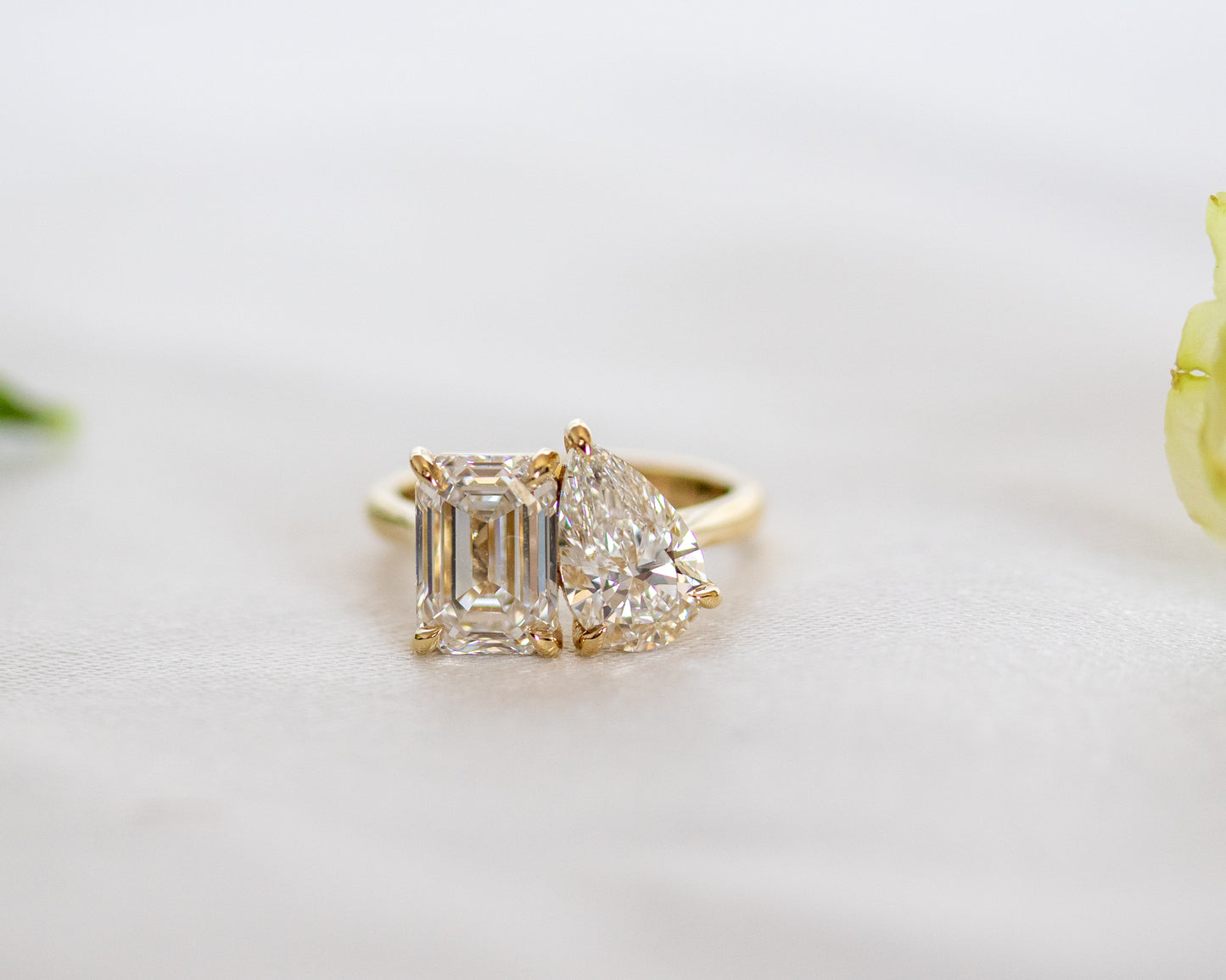 Emerald-cut and pear-cut two-stone Toi et Moi ring in 14K yellow gold, three-quarter view
