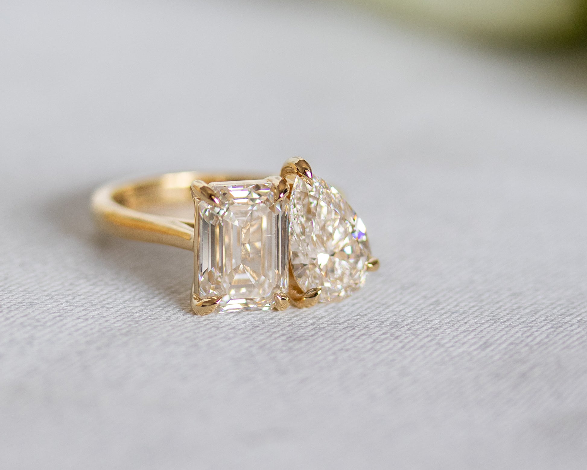 Toi et Moi ring with emerald-cut and pear-cut diamonds in 14K yellow gold, detail view