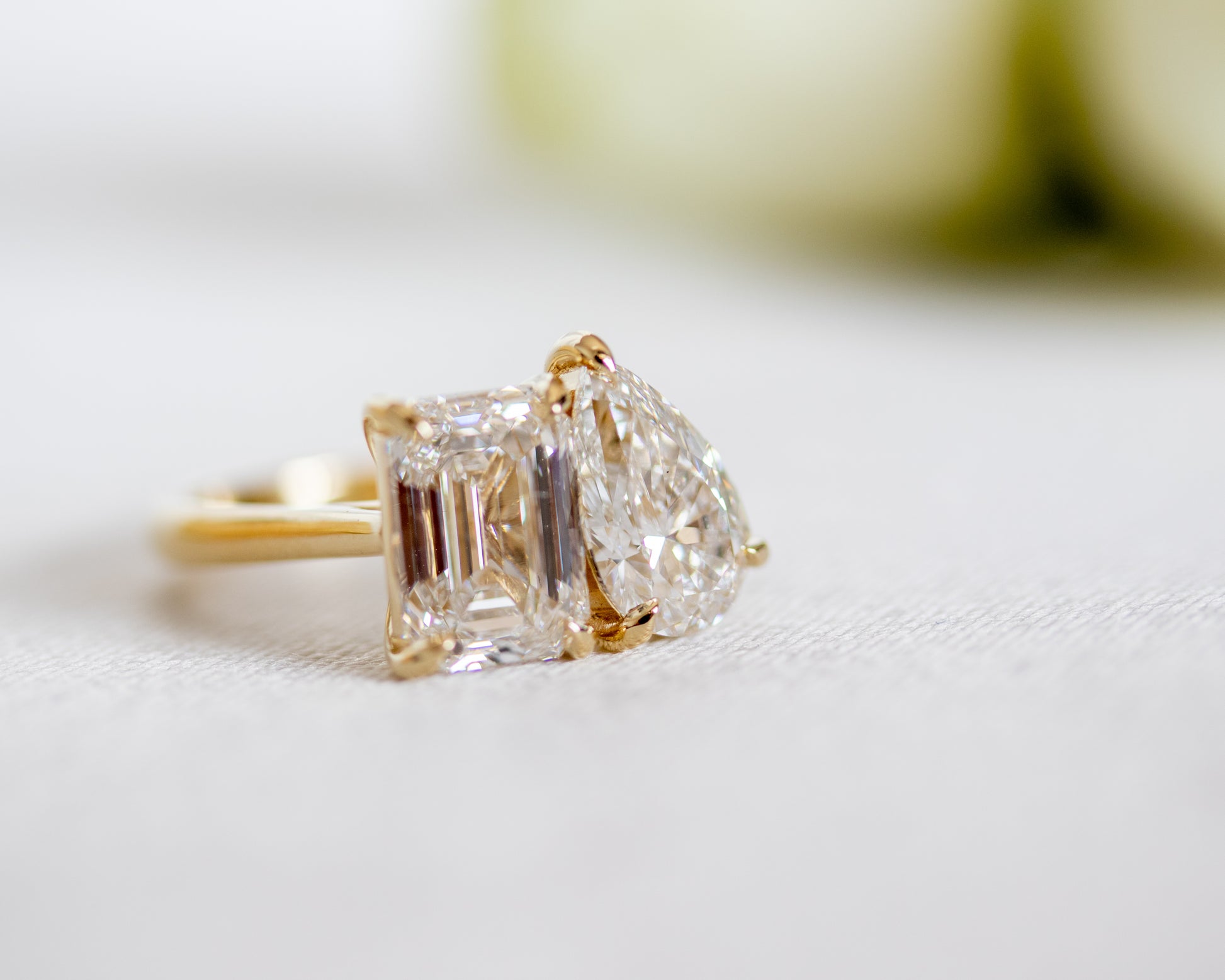 Toi et Moi two-stone diamond ring in 14K yellow gold on white fabric