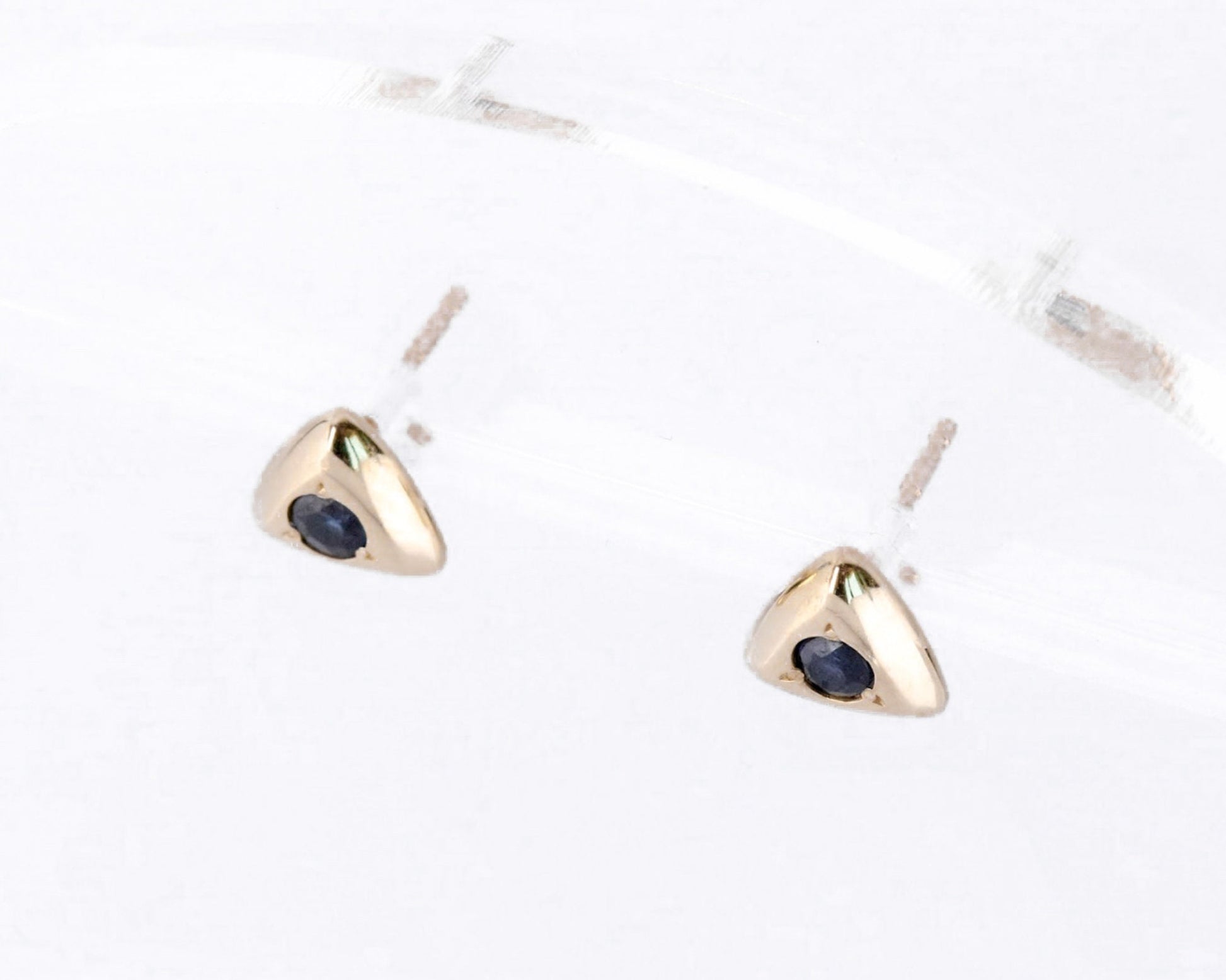 Triangular gold sapphire studs showing push-back posts