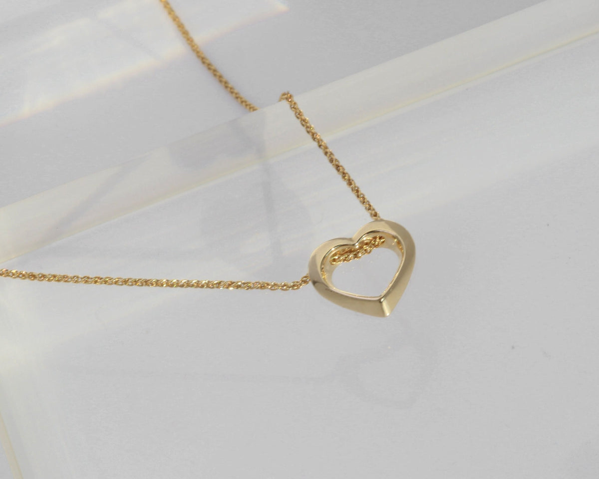 14K yellow gold twisted open heart with the spiga chain passing through it