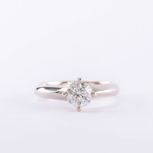 A 14K white gold solitaire ring with a round natural diamond centerpiece.