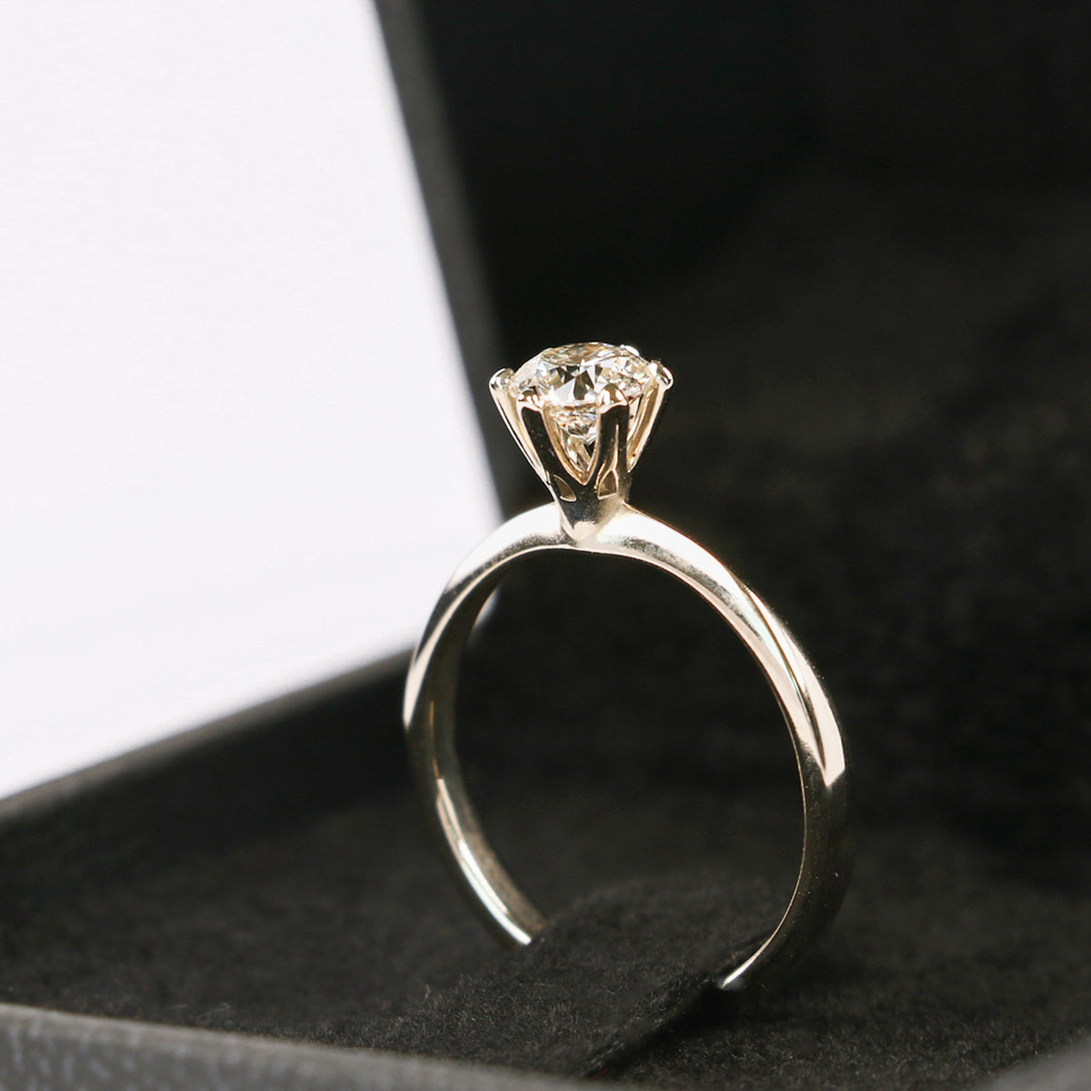 White gold six-prong diamond solitaire engagement ring in a black ring box
