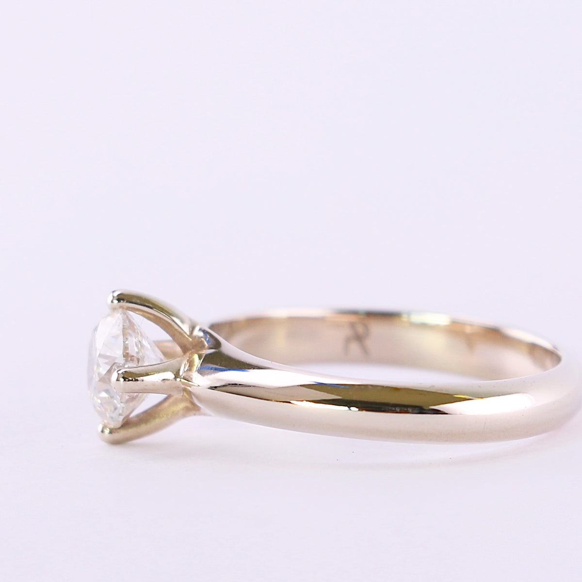 White gold round diamond solitaire engagement ring, side profile