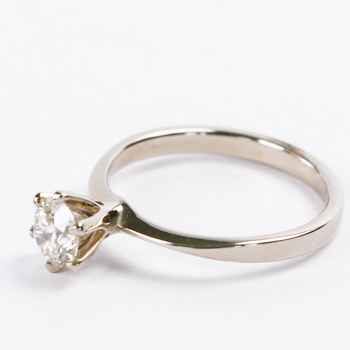 White gold six-prong diamond solitaire engagement ring with a flat band
