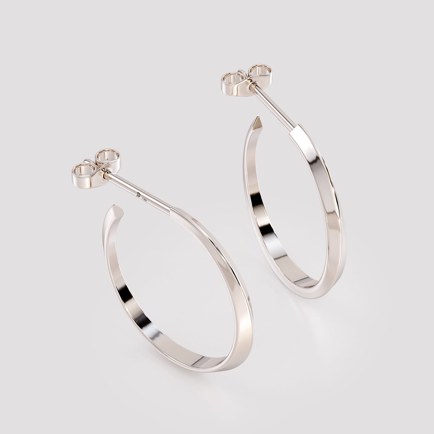 Pair of 14K white gold twist hoop earrings shown from angled top view, minimalist geometric fine jewelry with sculpted twist design on neutral gray background.