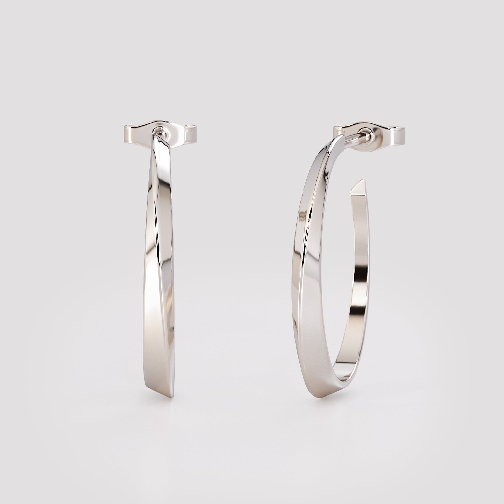 14K white gold twist hoop earrings with sculpted geometric design, modern minimalist fine jewelry photographed on soft gray background.