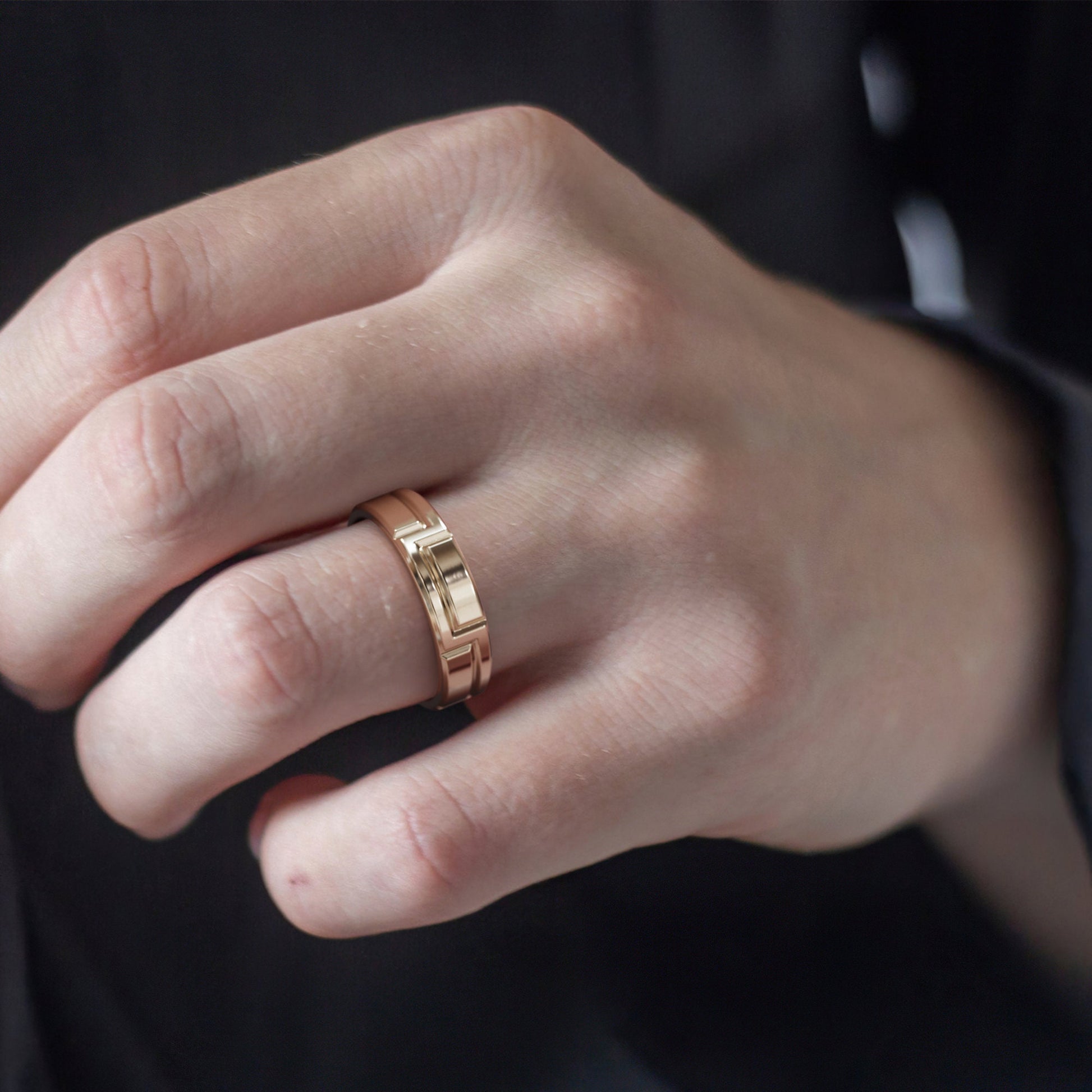 wide gold band geometric carving close up