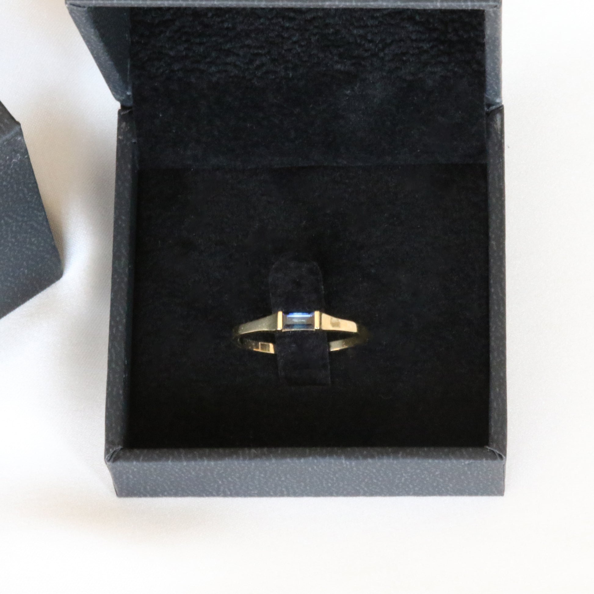 sapphire baguette ring in black velvet box 